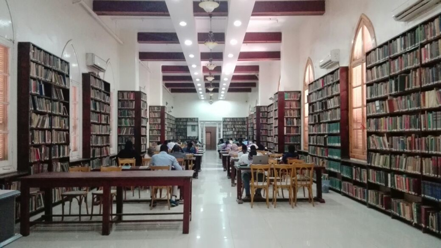 Students sitting at tables in a library in Sudan